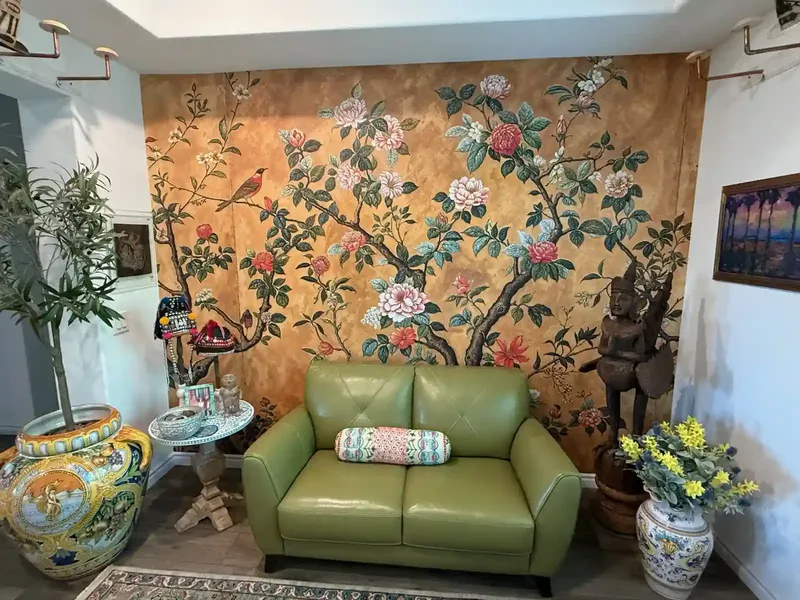Accent wall wallpaper installation with bold floral pattern
