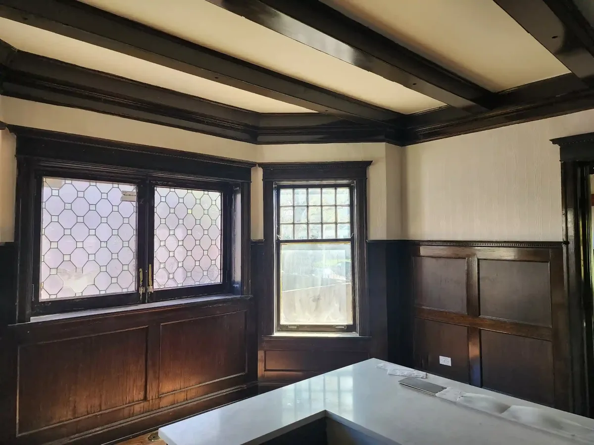 Historic plaster wall being prepared for wallpaper installation