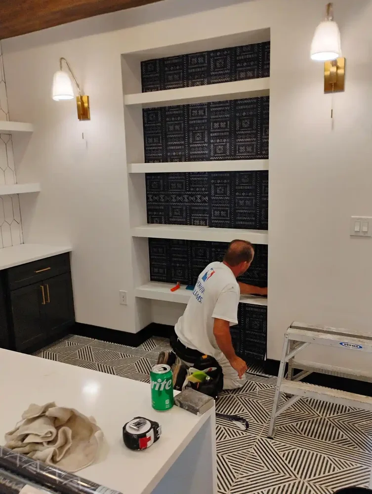 Detail and finish specialist ensuring perfect wallpaper seam alignment
