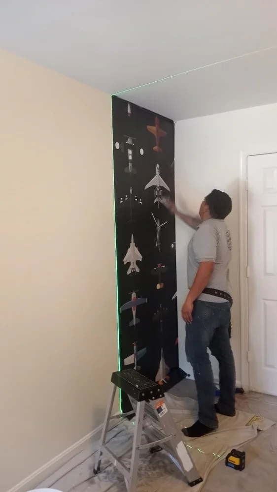 Experienced wallpaper installer working on a residential project