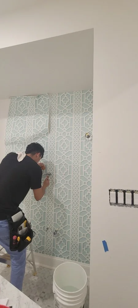 Wallcovering expert installing luxury materials